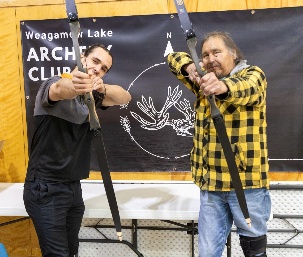 Man and woman shooting recurve bows — Burning Arrow community program