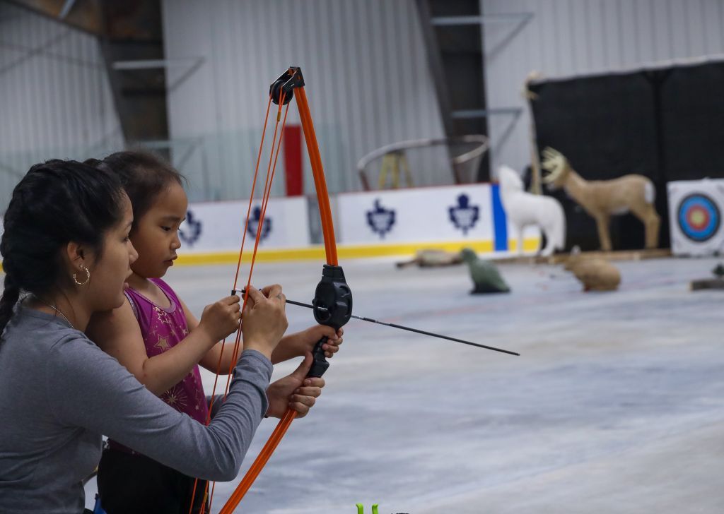 Harold showing kids how to adjust a compound bow — youth worker training